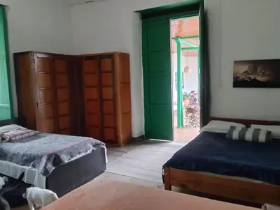 a bedroom with two beds and an open door at LUzArt in Jardin