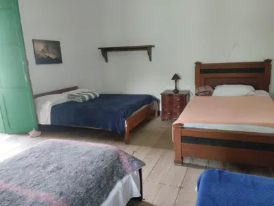 a room with two beds in a room at LUzArt in Jardin
