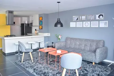 a living room with a couch and a kitchen at Espectacular apt 3 habitaciones deluxe! in Envigado