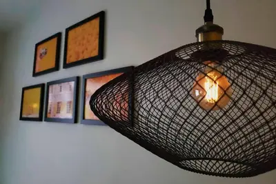 a hanging light in a room with pictures on the wall at Espectacular apt 3 habitaciones deluxe! in Envigado