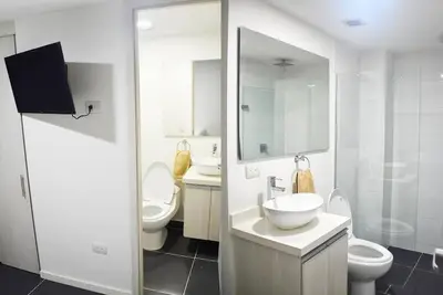 a white bathroom with two toilets and a sink at Espectacular apt 3 habitaciones deluxe! in Envigado