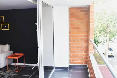 a glass door in a room with a brick wall at Espectacular apt 3 habitaciones deluxe! in Envigado