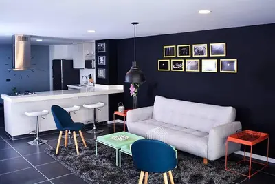 a living room with a couch and chairs and a kitchen at Espectacular apt de 3 habitaciones deluxe! in Envigado