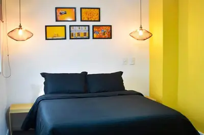 a bedroom with a bed and three pictures on the wall at Espectacular apt de 3 habitaciones deluxe! in Envigado
