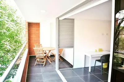 a small balcony with a table and chairs on it at Espectacular Apt de 3 habitaciones Deluxe! in Envigado