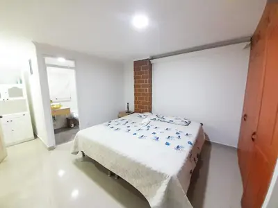 a bedroom with a bed and a brick wall at Precioso apartamento en Medellín con parqueadero gratis laure in Medellín