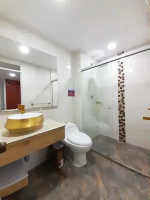 a bathroom with a gold sink and a toilet at Precioso apartamento en Medellín con parqueadero gratis laure in Medellín
