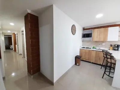 a kitchen with white walls and a counter top at Precioso apartamento en Medellín con parqueadero gratis laure in Medellín