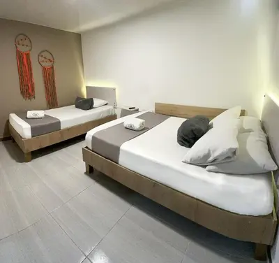 two beds in a room with two beds sidx sidx sidx sidx at Hotel Pass, Laureles Medellín in Medellín