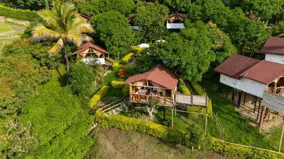 an aerial view of a resort with trees and houses at Glamping Mirador Santa Fe-Sopetran in Sopetran