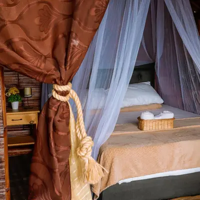 a bedroom with a bed with a canopy at Glamping Mirador Santa Fe-Sopetran in Sopetran