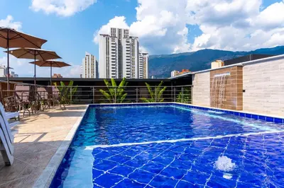 a swimming pool on the roof of a building at Hotel California City in Medellín