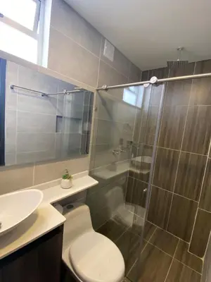 a bathroom with a shower and a toilet and a sink at Hotel California City in Medellín