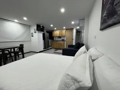 a bedroom with a white bed and a chalk board at Puesta de Sol El Carmen de Viboral in Carmen de Viboral