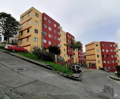 a street with buildings and cars parked in a parking lot at Fuera de Casa como en Casa in Manizales
