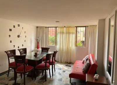 a living room with a dining room table and chairs at Fuera de Casa como en Casa in Manizales