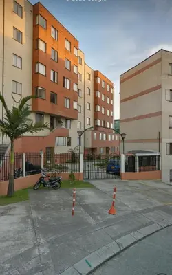 a parking lot with some orange cones in front of some buildings at Fuera de Casa como en Casa in Manizales