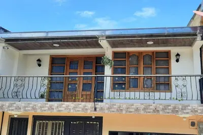 a house with a balcony with a fence at Casa central, segundo piso in Norcasia