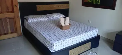 a small bed with two stuffed animals on it at Casa central, segundo piso in Norcasia