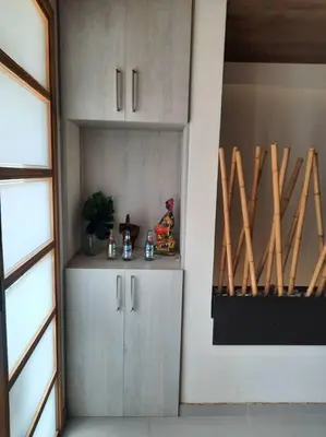 a kitchen with a white cabinet and some wooden bats at Casa central, segundo piso in Norcasia