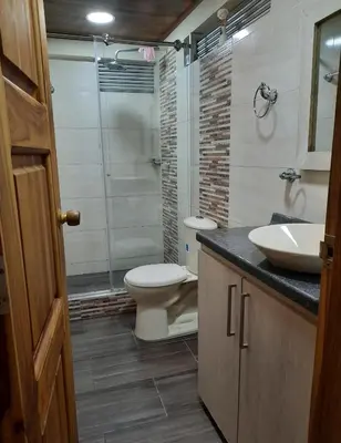 a bathroom with a toilet and a sink and a shower at Casa central, segundo piso in Norcasia