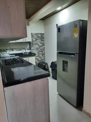 a kitchen with a refrigerator and a stove at Casa central, segundo piso in Norcasia