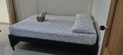 a small bed with a box on top of it at Casa central, segundo piso in Norcasia