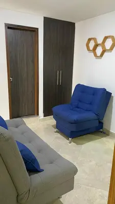 a living room with a couch and a blue sofa at Amoblado laureles San Joaquín in Medellín