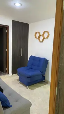 a blue couch sitting in a living room at Amoblado laureles San Joaquín in Medellín