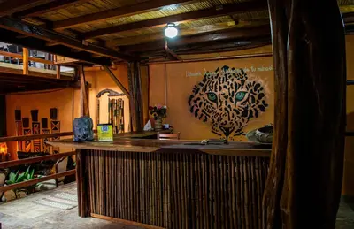 a bar in a room with a painting of a tree at Refugio del Jaguar in Medellín