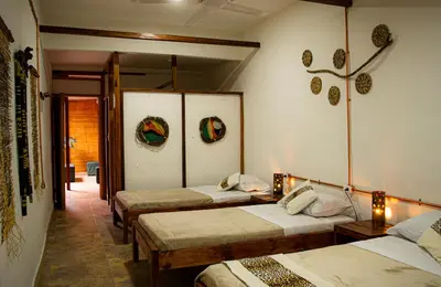 a room with four beds in a room with lights at Refugio del Jaguar in Medellín