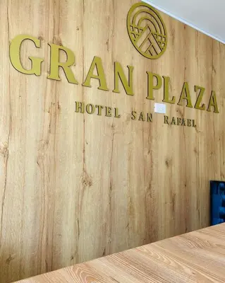 a sign for a hotel on a wooden wall at HOTEL GRAN PLAZA SAN RAFAEL in San Rafael