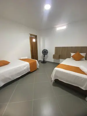 a hotel room with two beds and a fan at HOTEL GRAN PLAZA SAN RAFAEL in San Rafael