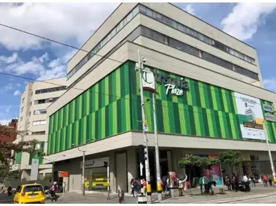 a green and white building on a city street at Hermoso loft en medellin in Medellín