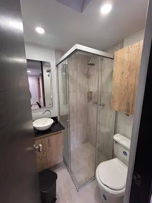 a bathroom with a shower and a toilet and a sink at Hermoso loft en medellin in Medellín