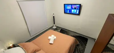 a room with a bed with a teddy bear on it at Hermosa Habitación in Medellín