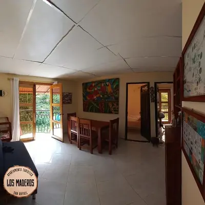 a living room with a table and a dining room at Los Maderos San Rafael Antioquia Apartamento Turístico in San Rafael