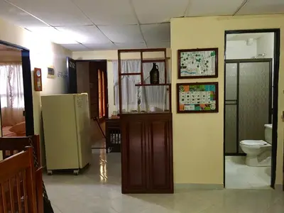 a room with a refrigerator and a toilet at Los Maderos San Rafael Antioquia Apartamento Turístico in San Rafael