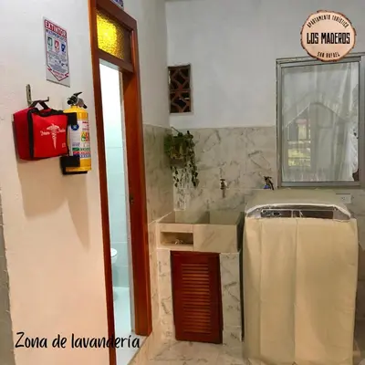 a bathroom with a counter and a sink and a mirror at Los Maderos San Rafael Antioquia Apartamento Turístico in San Rafael