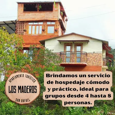 a house with a sign in front of it at Los Maderos San Rafael Antioquia Apartamento Turístico in San Rafael