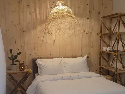 a bedroom with a bed and a chandelier at Tuku, in Guarinocito