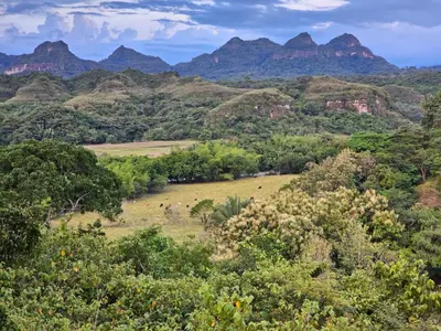 a view of a valley with mountains in the background at Tuku, in Guarinocito