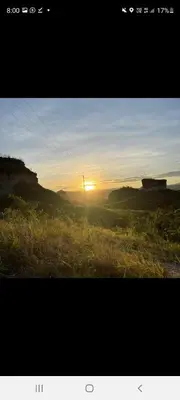 a picture of a sunset in a field at Tuku, in Guarinocito