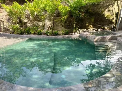 a swimming pool with blue water at Tuku, in Guarinocito