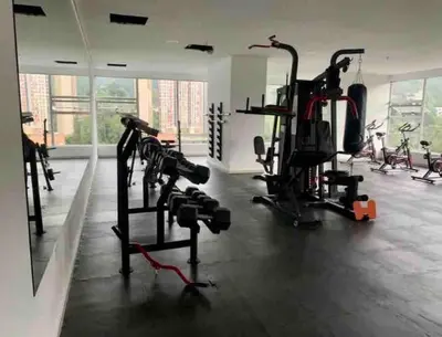 a gym with several tread machines in a room at Piso26 Beautifull Apartment and Parking in Sabaneta