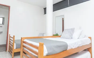 a bedroom with a wooden bed and a mirror at Hotel Villa Park Real in Medellín