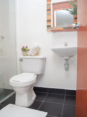 a bathroom with a toilet and a sink at Hotel Villa Park Real in Medellín