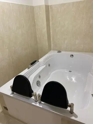a bath tub with two chairs in a bathroom at Hotel la Victoria in San Roque