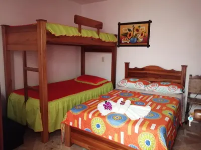 a bedroom with two bunk beds in a room at Las Orquídeas Jardín Casa Hotel in Jardin