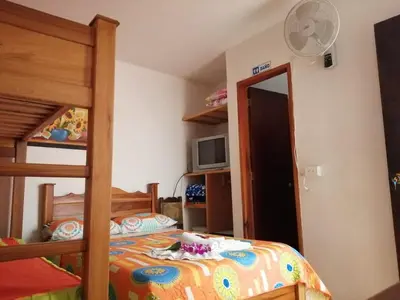 a bedroom with a bed and a bunk bed at Las Orquídeas Jardín Casa Hotel in Jardin